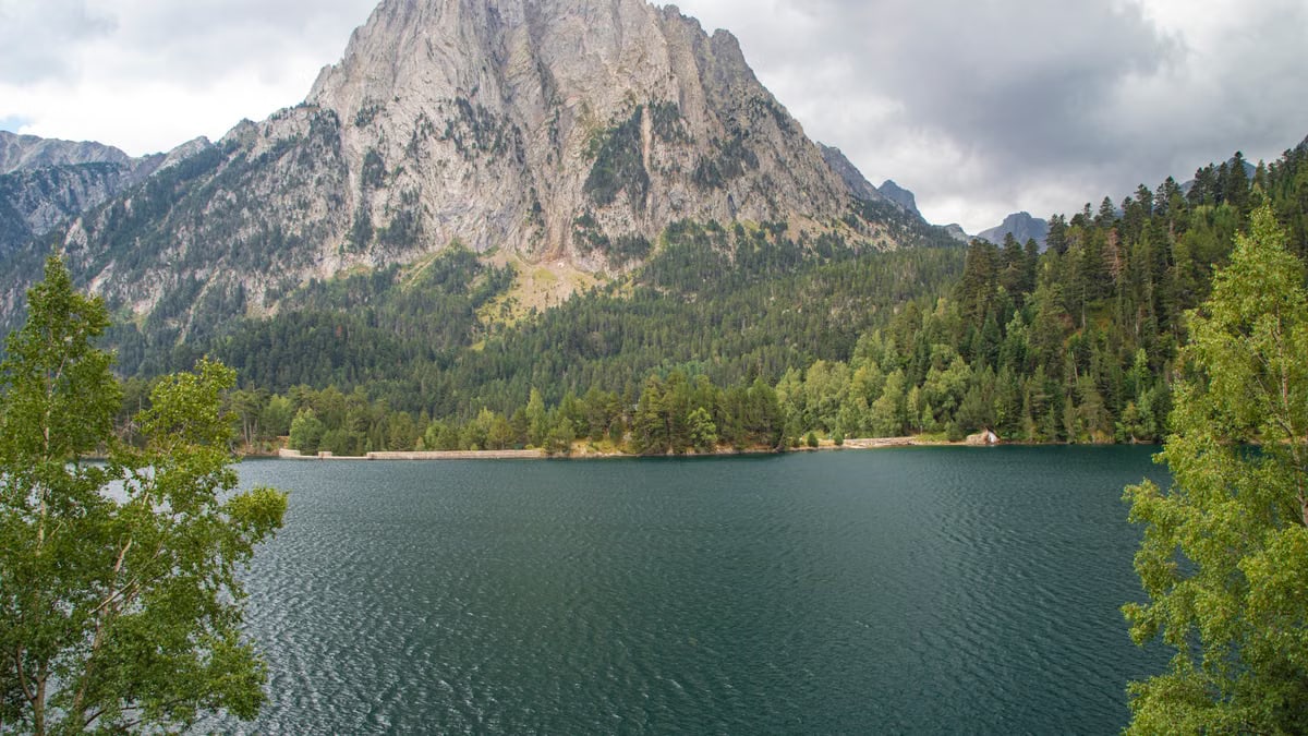 Beautiful landscape of Estany de Sant Maurici with Gran Encantat in the background, Catalonia, Spain.